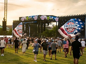 Attendees walk past the main stage during the UFC Freedom 250 Fan Fest on The Ellipse ahead of the upcoming UFC Freedom 250 fight on the South Lawn of the White House on June 13, 2026 in Washington, DC.