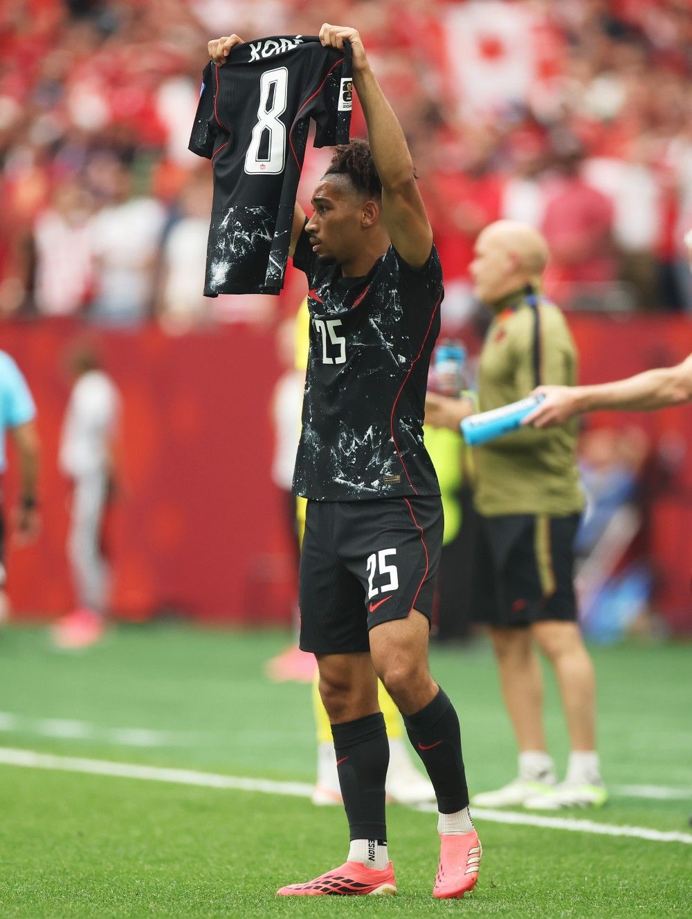 Canada’s Nathan Saliba displays the shirt of Ismael Kone, who left the game with a leg injury, after scoring the team’s fourth goal during the FIFA World Cup 2026 Group B match against Qatar at B.C. Place Vancouver on Thursday, June 18, 2026.