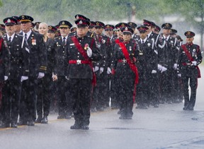 Rain falls during the police funeral procession for OPP Const. Tarun Bali at the Mississauga Sports and Entertainment Centre on Thursday, June 18, 2026. Const. Bali was killed in the line of duty on June 9.