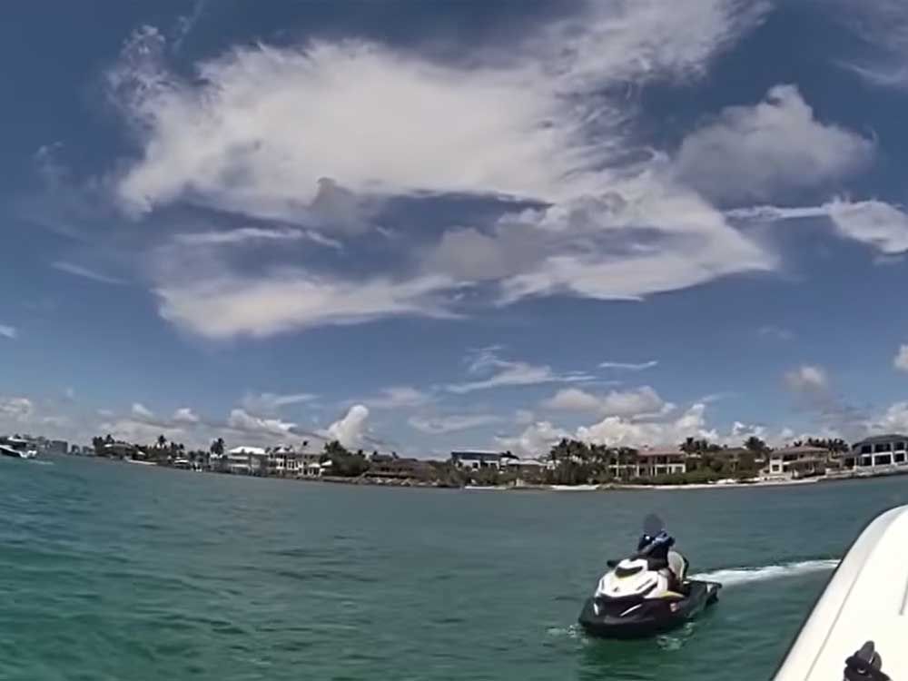 An eight-year-old boy riding a jet ski was stopped by Sarasota police in this screengrab of a video shared by the Sarasota Police Department.