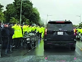 First responders salute a procession for slain Toronto Police Const. Marc Pinizzotto.