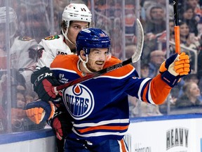 Edmonton Oilers’ Jack Roslovic checks the Chicago Blackhawks’ Kevin Korchinski during a game earlier this year.