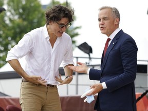 Prime Minister Mark Carney (right) is greeted by former Prime Minister Justin Trudeau
