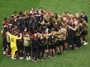 Canada players huddle after their team lost 3-0 to Morocco