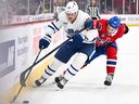 Toronto Maple Leafs' David Kampf and Jayden Struble of the Montreal Canadiens skate after the puck during a game in 2024.