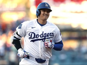 Shohei Ohtani of the Los Angeles Dodgers reacts to a solo home run, his 300th for his career, to take a 1-0 lead over the Colorado Rockies, during the first inning at Dodger Stadium on July 7, 2026 in Los Angeles.