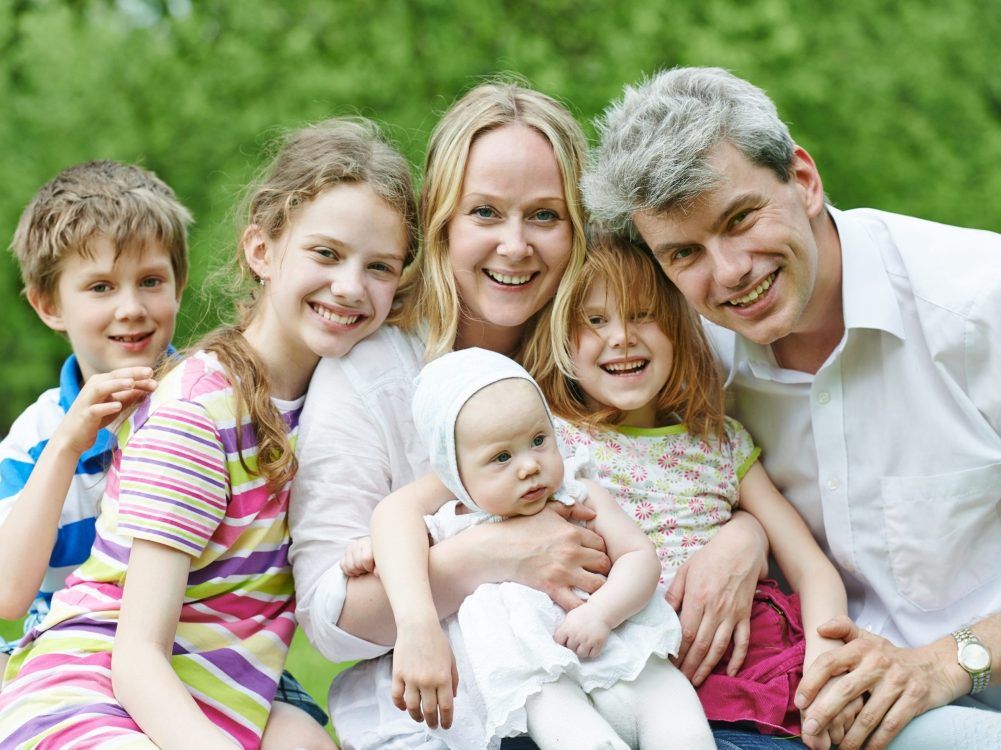 Parents with four children in the countryside.