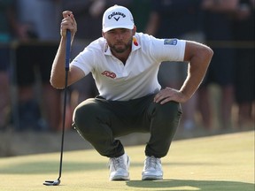 Sam Burns lines up a putt on the 15th green