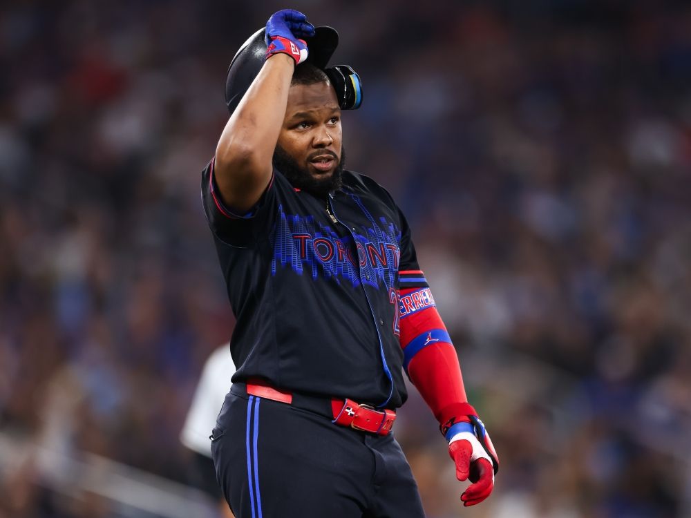 Vladimir Guerrero Jr. of the Toronto Blue Jays takes off his batting helmet after flying out against the Chicago White Sox.
