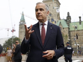 Prime Minister Mark Carney speaks to journalists