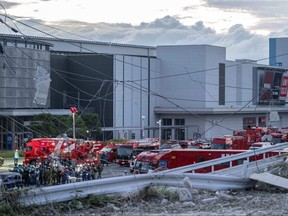 Emergency vehicles and workers are seen outside the Aeon Mall