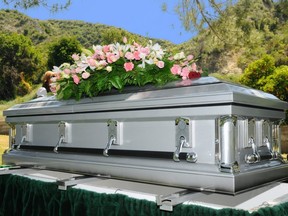 Image of a stainless steel casket with flowers