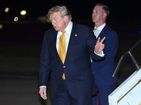 U.S. President Donald Trump disembarks from Air Force One.
