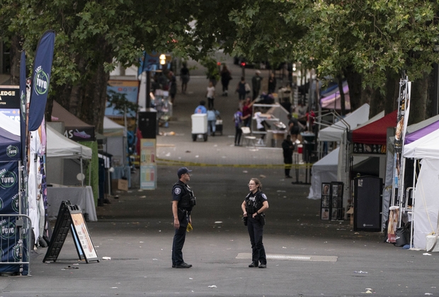  Police officers keep watch after a mass shooting at the Bite of Seattle food festival on July 26, 2026 in Seattle, Washington. Three people are dead and multiple people are wounded. Seattle mayor Katie Wilson said one suspect is in custody.