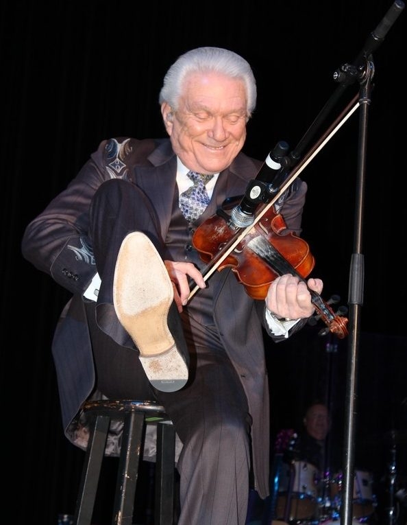  Tommy Hunter shows off his fiddling talent by playing under his leg during his farewell tour. The show was held in March at the James M. Hill Theatre.