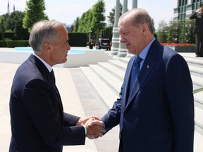 This handout photo taken and released by the Turkish presidential press service shows Turkey's President Recep Tayyip Erdogan (right) welcoming Prime Minister Mark Carney at the Presidential Complex in Ankara ahead of the 36th NATO Heads of State and Government Summit, Tuesday, July 7, 2026.