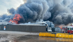 Norfolk County firefighters are on the scene of a massive structure fire at a hog farm on Highway 3 just west of Simcoe, Ontario. The structure – estimated at about four acres in size — is a total loss, and at least 20,000 pigs have perished in the blaze that continues to burn on Tuesday morning, July 14, 2026. (Norfolk County Fire Department)