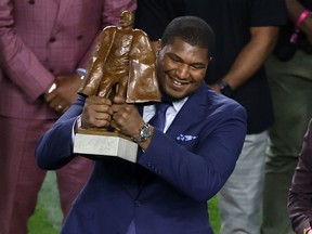 Calais Campbell of the Jacksonville Jaguars is awarded the Walter Payton NFL Man of the Year Award prior to Super Bowl LIV between the San Francisco 49ers and the Kansas City Chiefs at Hard Rock Stadium on February 02, 2020 in Miami, Florida.