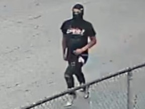 Surveillance footage of a masked suspect.