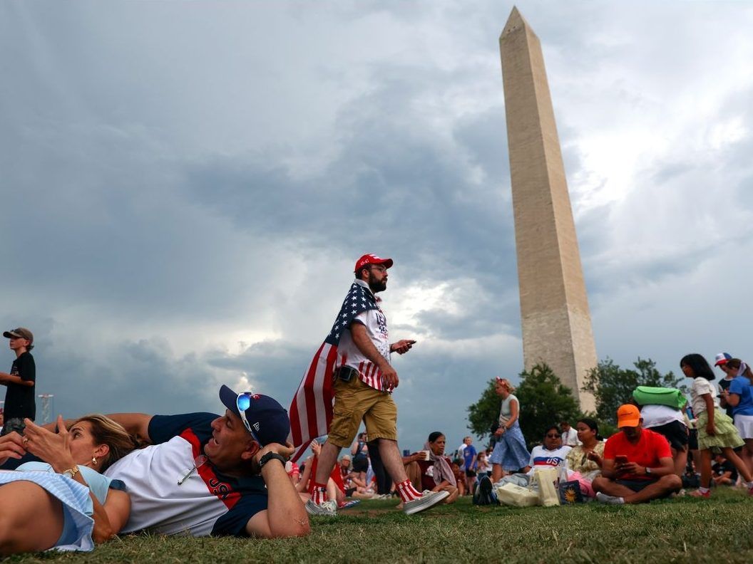 Storm clouds gather over the National Mall as people celebrate the Fourth of July in Washington, D.C., Saturday, July4, 2026.