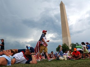 Storm clouds gather over the National Mall as people celebrate the Fourth of July in Washington, D.C., Saturday, July4, 2026.