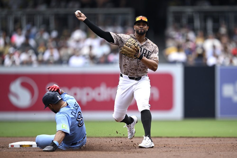 Padres' Xander Bogaerts throws to first base after forcing out Blue Jays' Jonatan Clase at second base during the second inning at Petco Park on July 12, 2026 in San Diego.