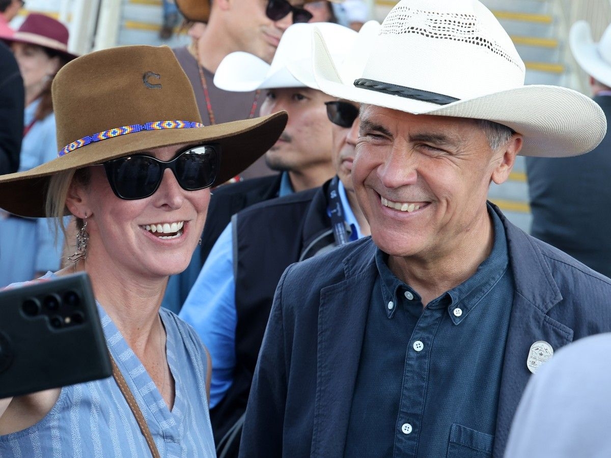  Prime Minister Mark Carney mingles with visitors before the GMC Rangeland Derby at the Calgary Stampede on Saturday, July 11, 2026.
