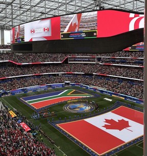 Flags of South Africa and Canada are displayed on the pitch