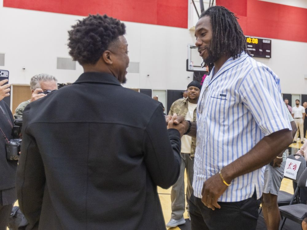 Kawhi Leonard greets Toronto Raptors legend Kyle Lowry, who announced his retirement from the NBA signing a one-day contract with the team last month.