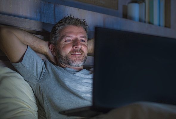 Man watching porn on his laptop