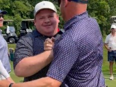 Amateur golfer Zach Holland celebrates after sinking a putt.