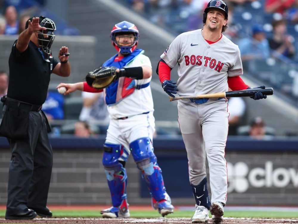Adley Rutschman of the Boston Red Sox reacts after striking out i