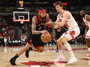 Brandon Ingram of the Toronto Raptors dribbles the ball as Matas Buzelis of the Chicago Bulls defends during a game last season.