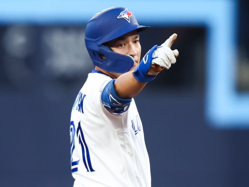 Brett Bateman of the Toronto Blue Jays celebrates on second base after hitting an RBI-double against the Boston Red Sox.