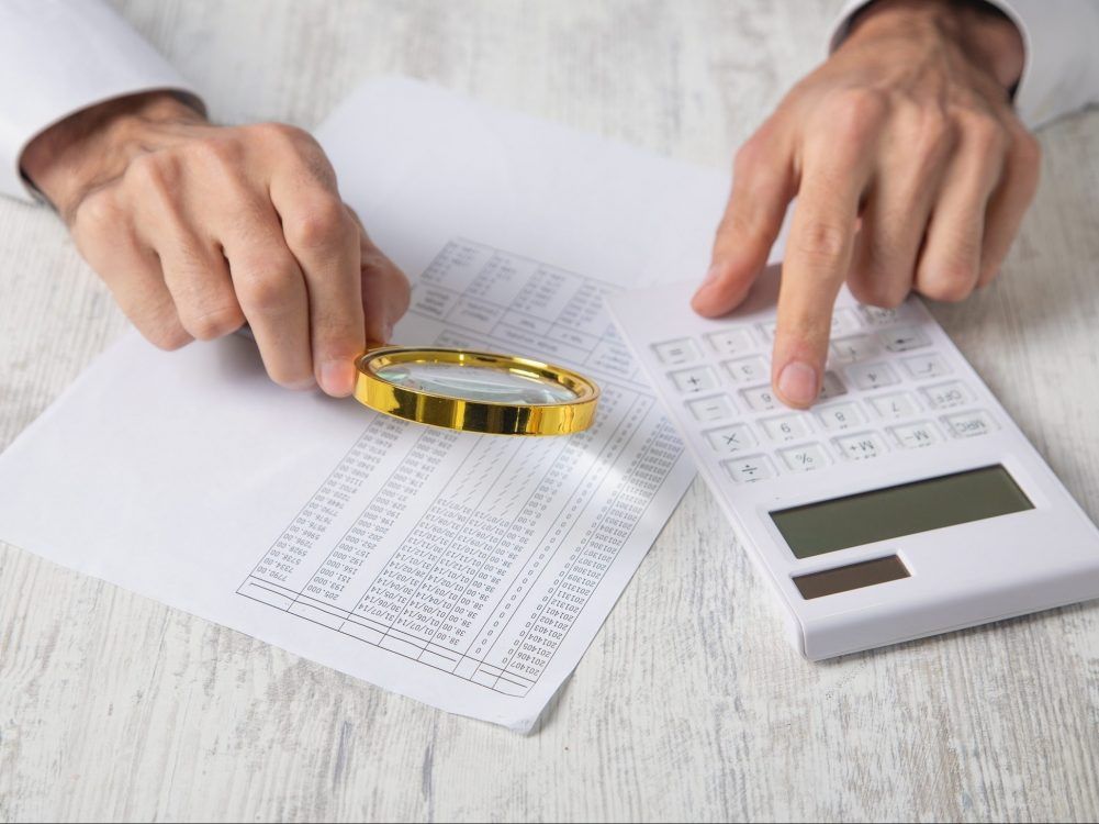 Using a calculator to determine how to share family expenses.
