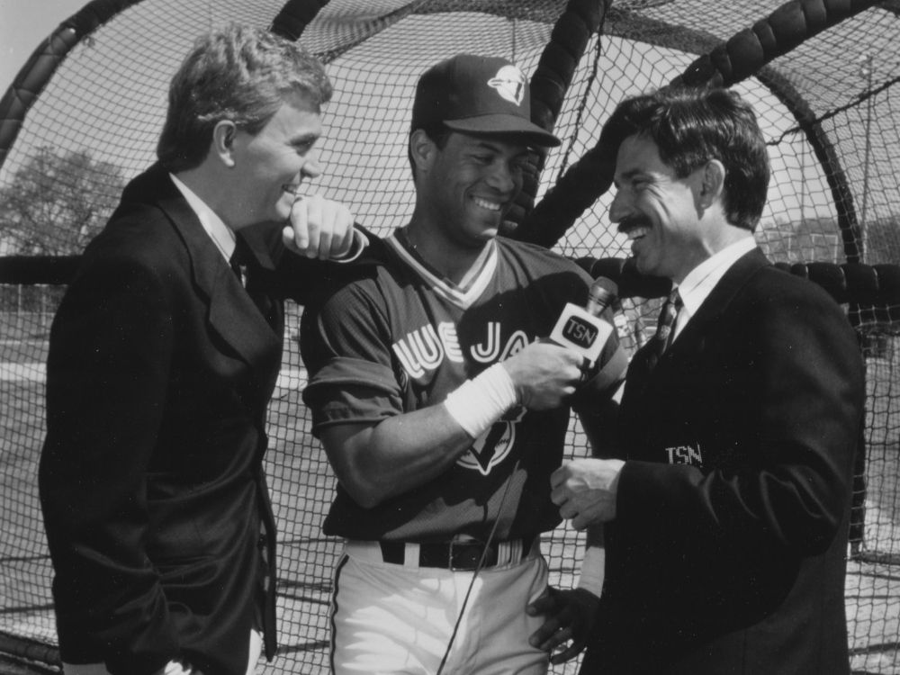 Former Toronto Blue Jays star Roberto Alomar interviews Buck Martinez while Jim Hughson looks on. 