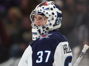 Connor Hellebuyck of the Winnipeg Jets tends goal against the Boston Bruins during a game this past season.