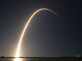 A SpaceX Falcon 9 rocket, carrying Firefly Aerospace’s Blue Ghost and ispace’s Resilience lunar landers, streaks into orbit after lifting off from Launch Complex 39A at the Kennedy Space Center in Cape Canaveral, Florida, on January 15, 2025. (Gregg Newton/AFP/Getty Images)