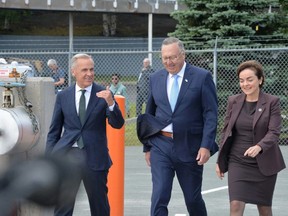 Canadian Prime Minister Mark Carney, Newfoundland and Labrador Premier Tony Wakeham and Quebec Premier Christine Fréchette walk towards the podium on Monday, Aug. 17, 2026 to announce a new Churchill Falls deal.