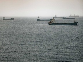 Crude oil tankers, bulk carriers and vessels anchored off Muscat, Oman.