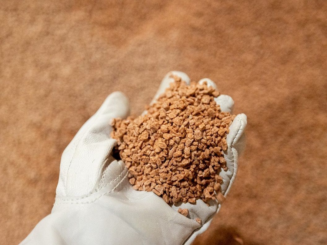 A worker shows potash stored in Allan, Sask., on  Oct. 1, 2024.  