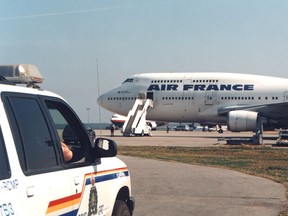 An RCMP vehicle watches over an Air France plane at the Gander International Airport during 9/11.