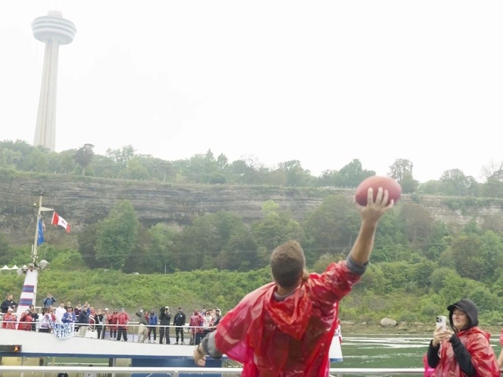 Former Buffalo Bills QB Ryan Fitzpatrick catches a ball thrown by Stevie Johnson across the Canada-U.S. border.