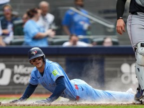 Ernie Clement of the Toronto Blue Jays slides into home plate against the Detroit Tigers earlier this month.