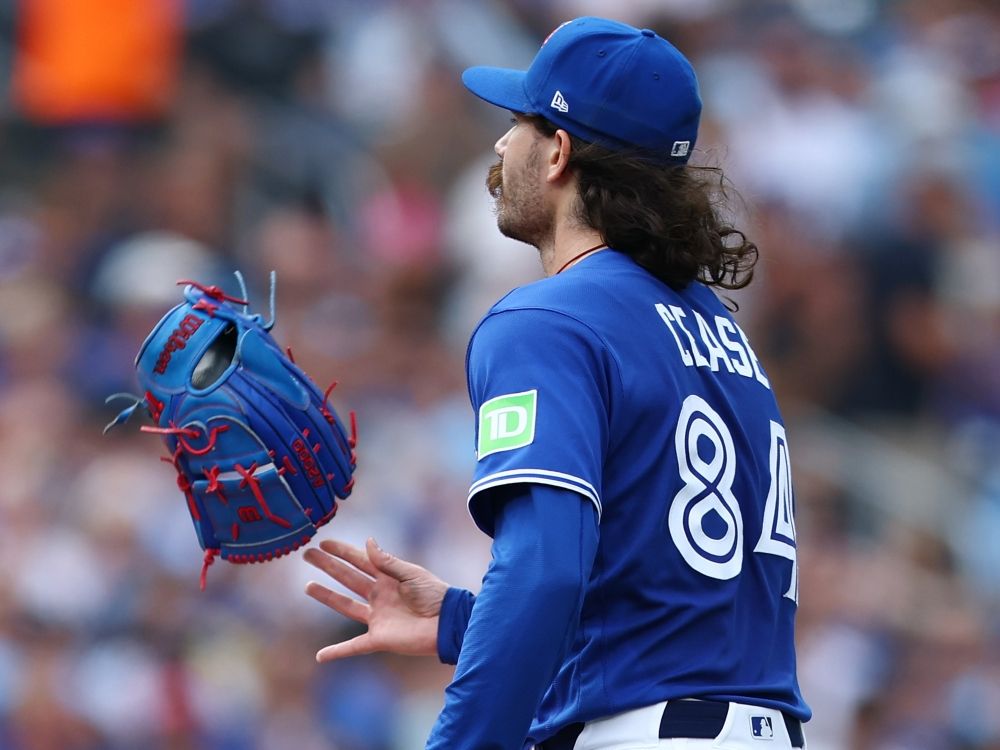 Dylan Cease of the Toronto Blue Jays tosses his glove in the air at the end of the fifth inning during a game against the Baltimore Orioles.