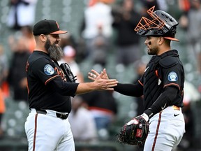 Pitcher Andrew Kittredge of the Baltimore Orioles (left)