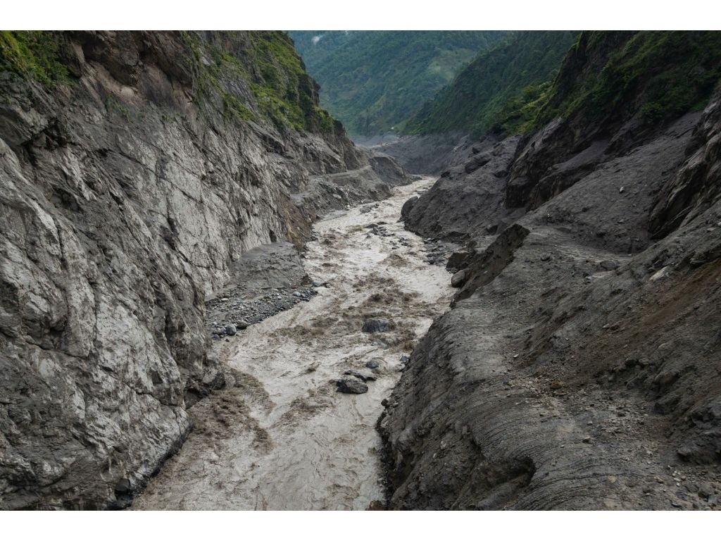 The gigantic wave of freezing water, rocks and debris from a high-altitude glacial collapse roared downstream on Wednesday. (Prabin Ranabhat/AFP)