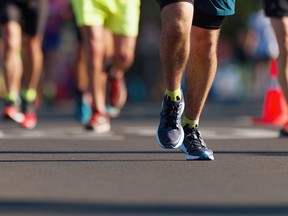 Marathon running race, people feet on city road