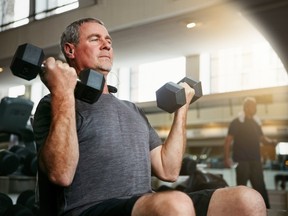 Fitness, gym and senior man with dumbbells for weightlifting, challenge or cardio workout, training or bodybuilding. Biceps, arms and elderly person with hand weight for strength, mindset or exercise