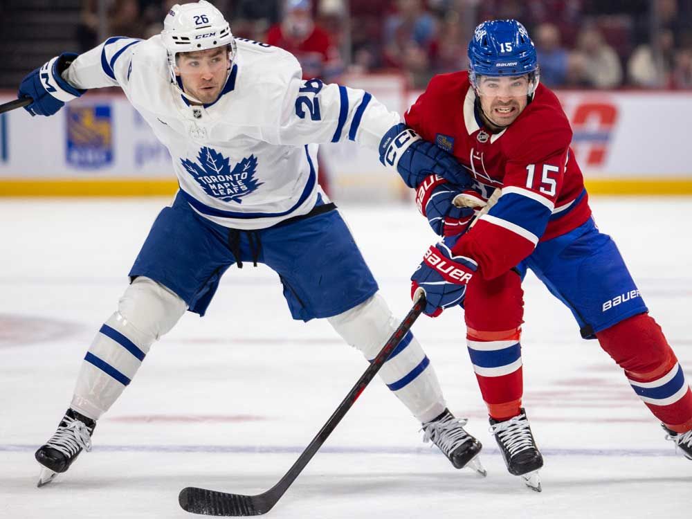 In this file photo taken on March 10, 2026, Montreal Canadiens Alex Newhook is helped up by Toronto Maple Leafs Jacob Quillan during third period of their NHL game in Montreal.